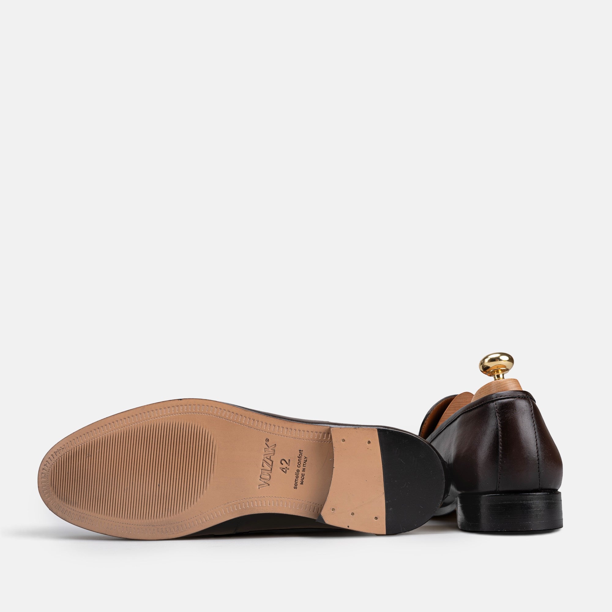 VOLZAK brown leather dress shoe showing the sole and heel with a wooden shoe tree inserted