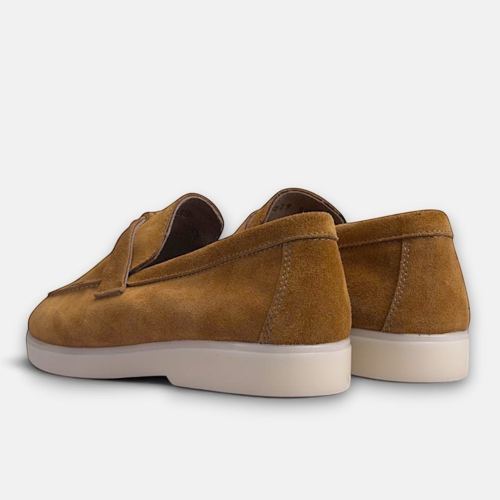 VOLZAK 279 camel suede loafers with a white rubber sole, shown from a rear angle.