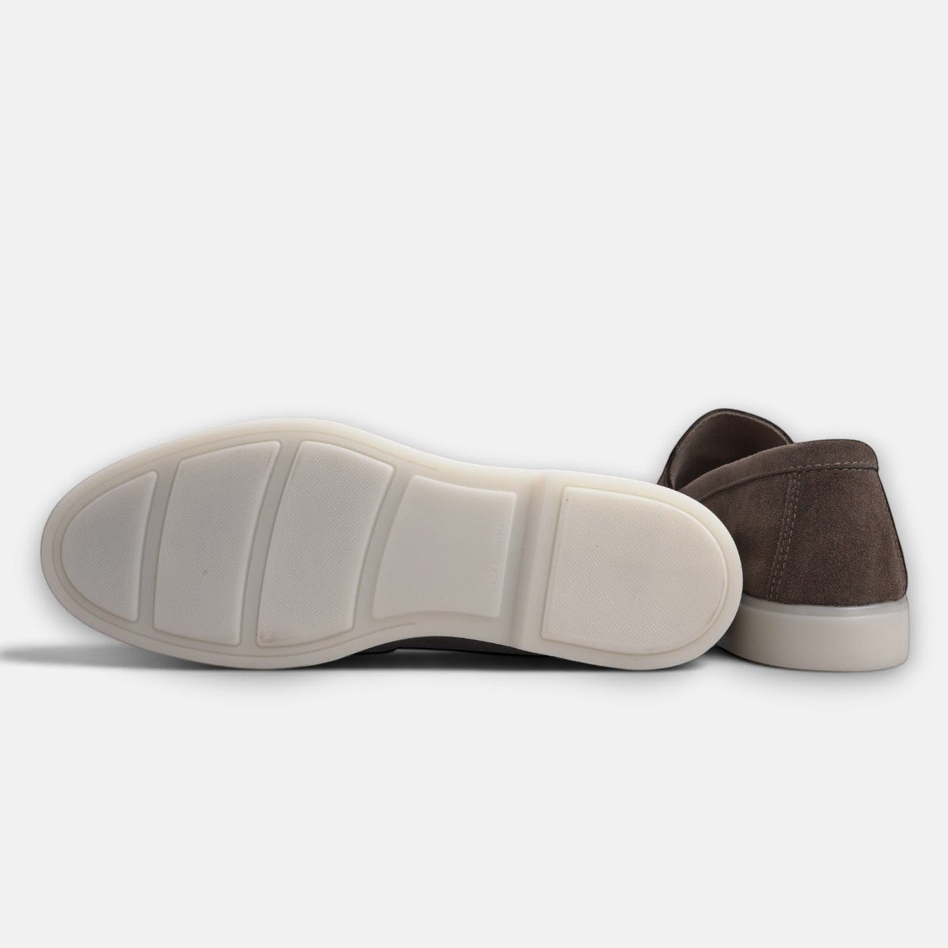 VOLZAK dark taupe suede moccasin showing the white rubber sole and heel detail against a plain background
