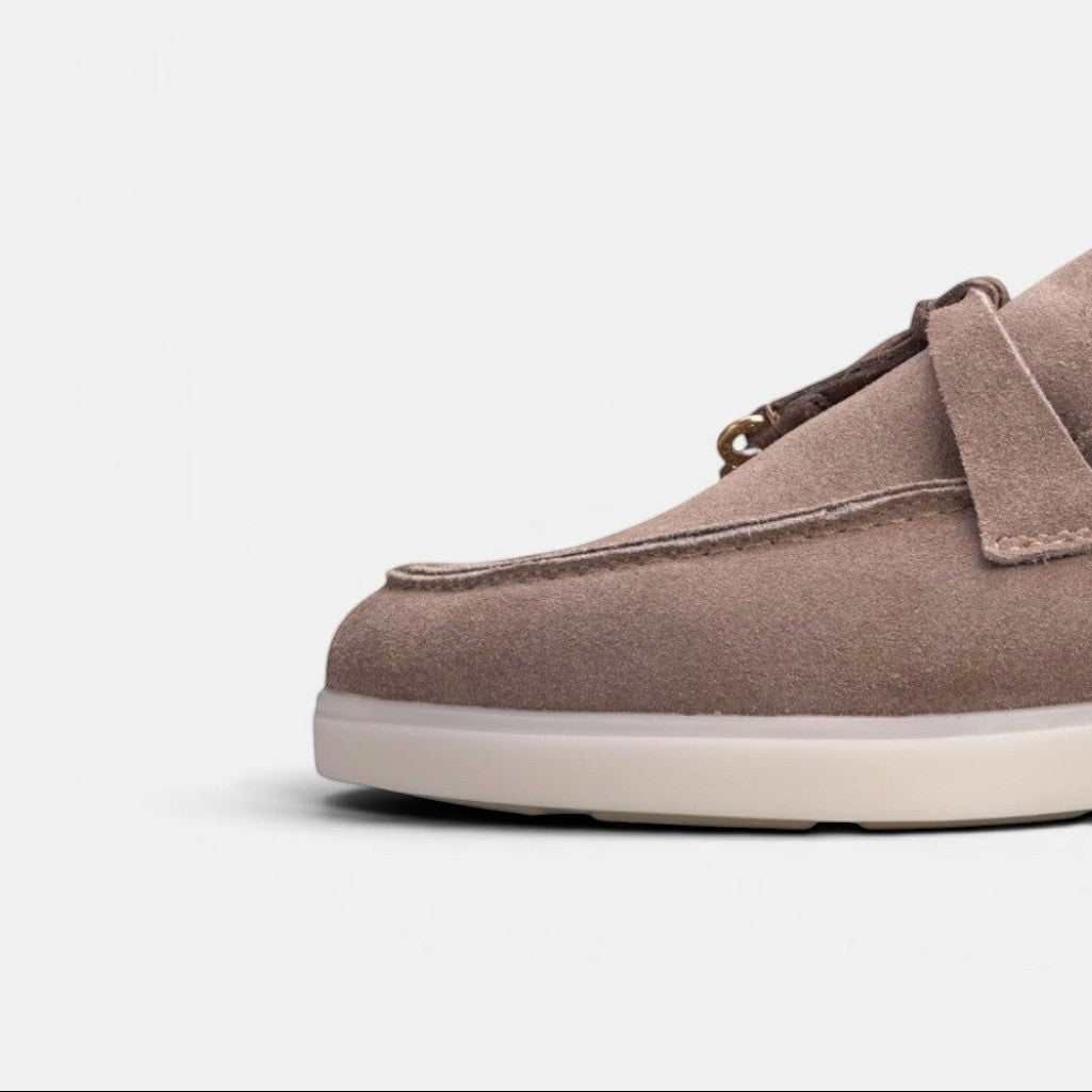 Close-up of a VOLZAK taupe suede moccasin featuring a durable rubber sole and detailed stitching.