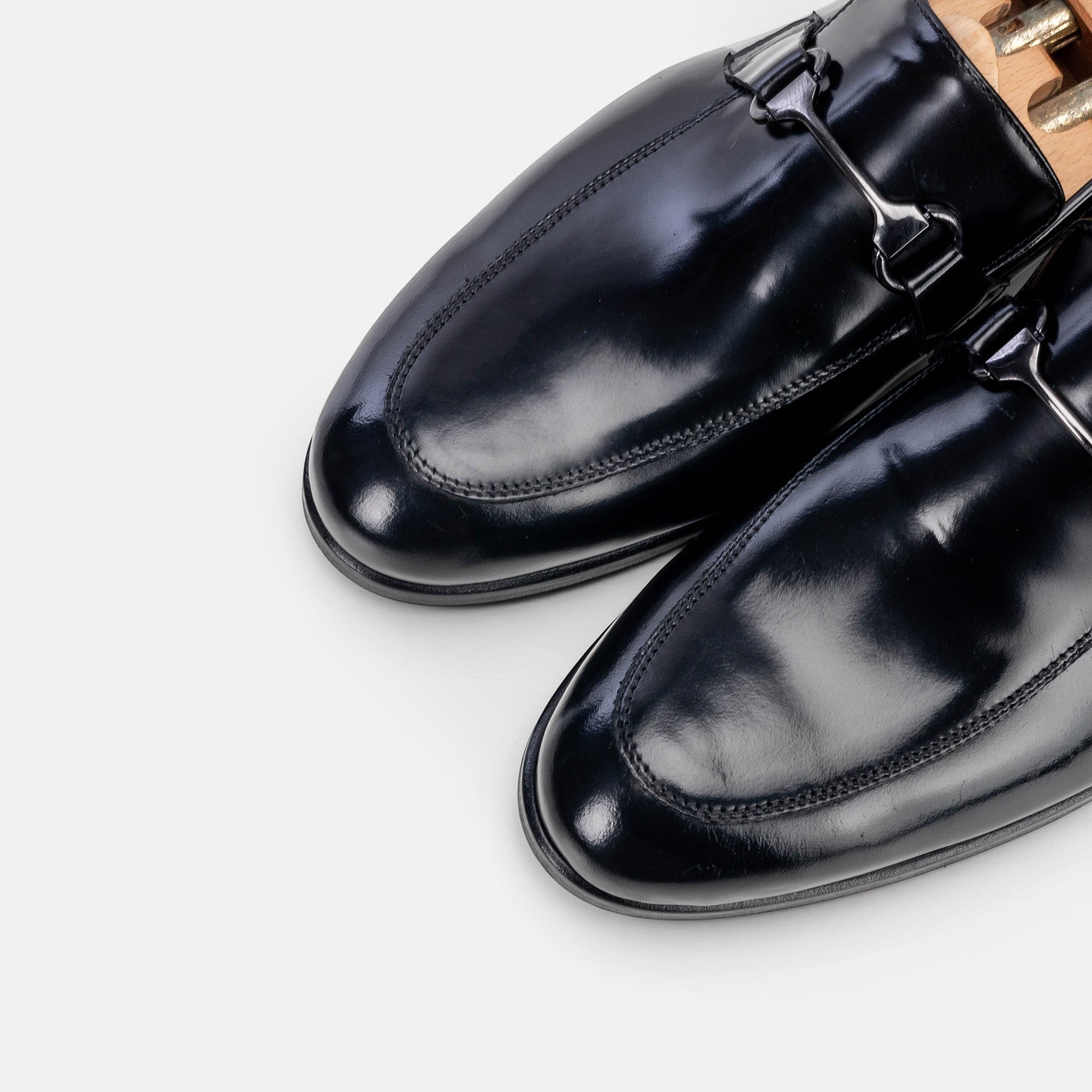VOLZAK black leather loafers with a polished finish and metal bit detail, featuring a classic slip-on design.