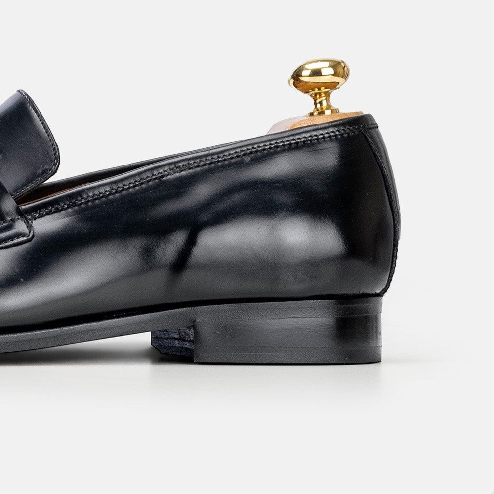 VOLZAK black leather loafer with a polished finish and wooden shoe tree insert, side view