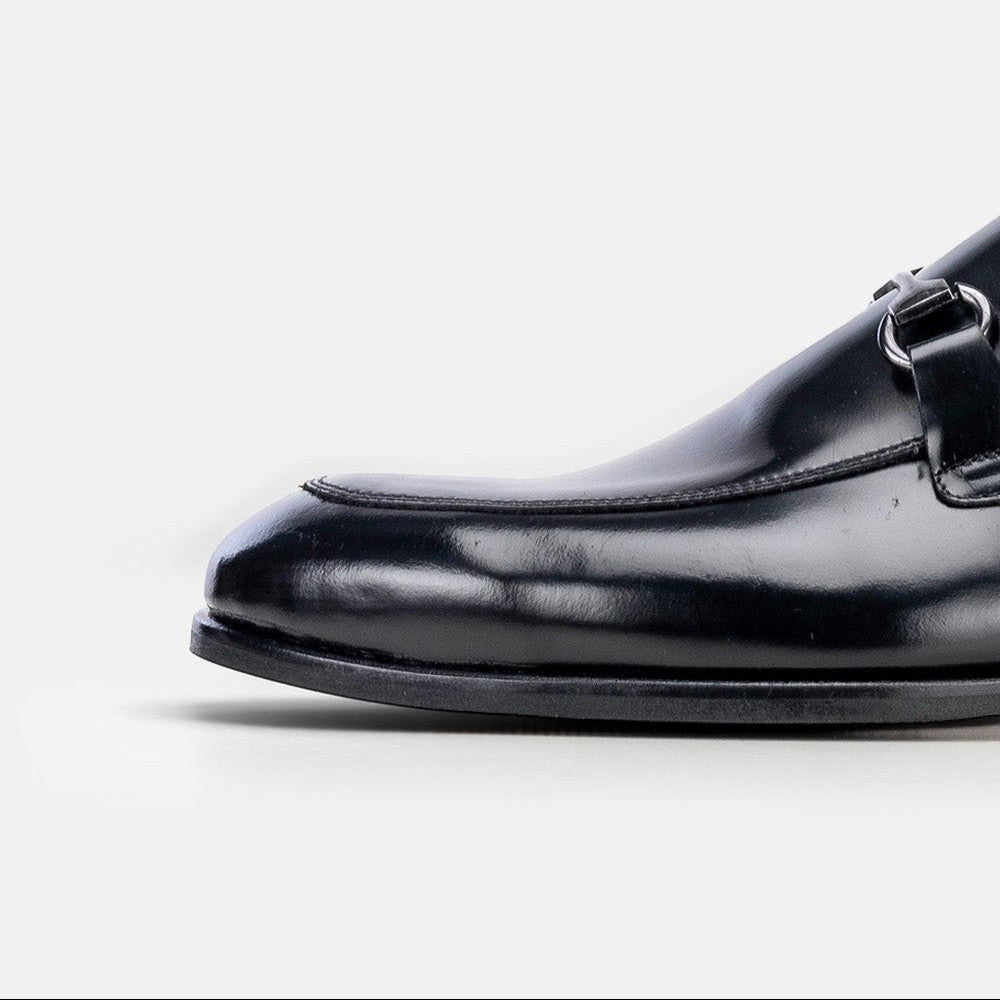 VOLZAK black leather loafer with a polished finish and silver metal buckle detail, side view