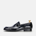 VOLZAK black leather loafer with a polished finish and metal bit detail, side view