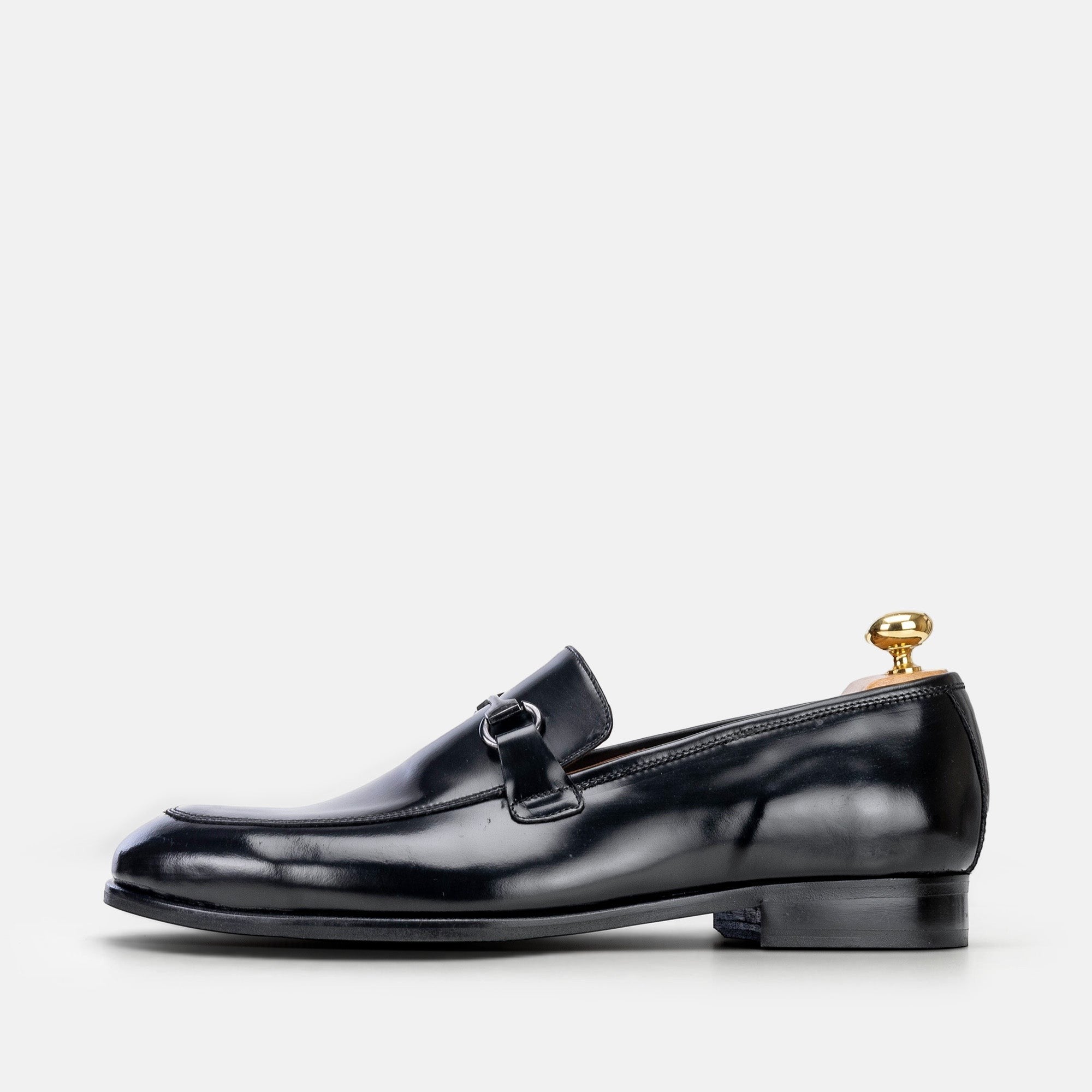 VOLZAK black leather loafer with a polished finish and metal bit detail, side view