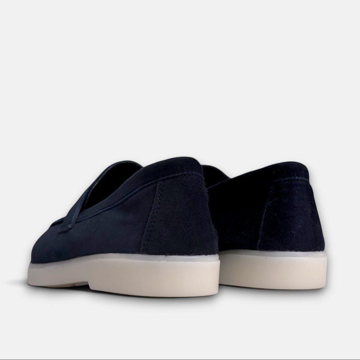 VOLZAK blue suede moccasins with a thick white rubber sole, viewed from the back