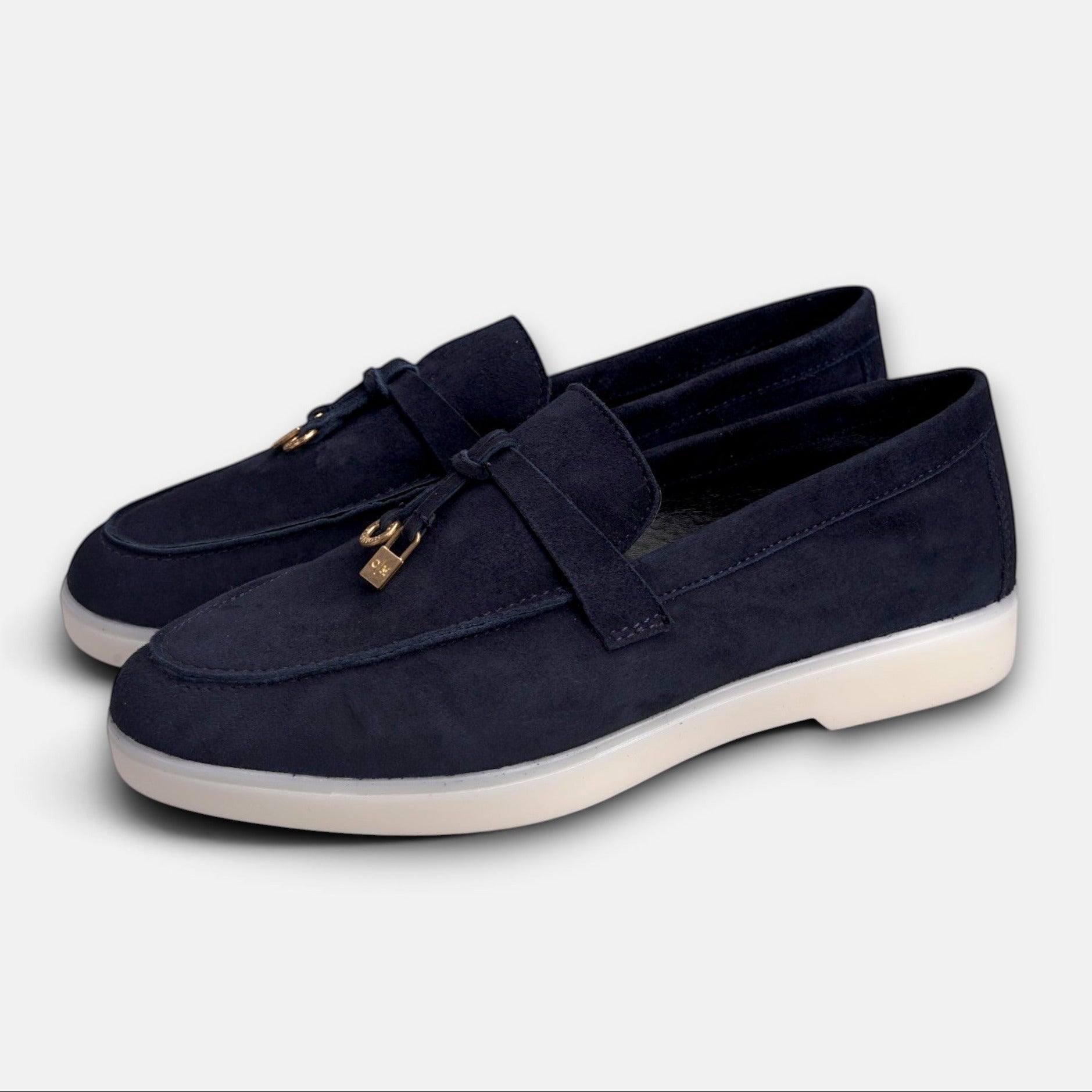 VOLZAK blue suede moccasins with leather lining, white rubber sole, and gold-toned tassel hardware detail.