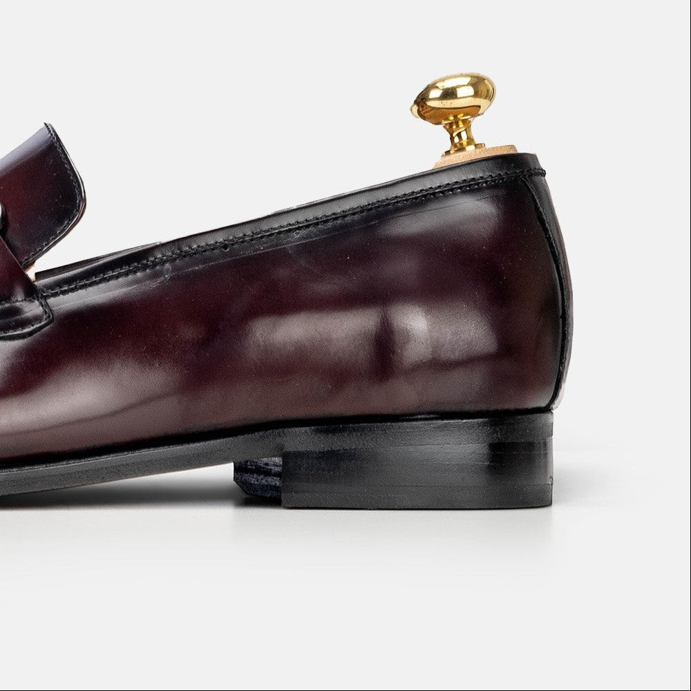 VOLZAK bordeaux leather loafer with a polished finish and gold-tone heel detail, side view