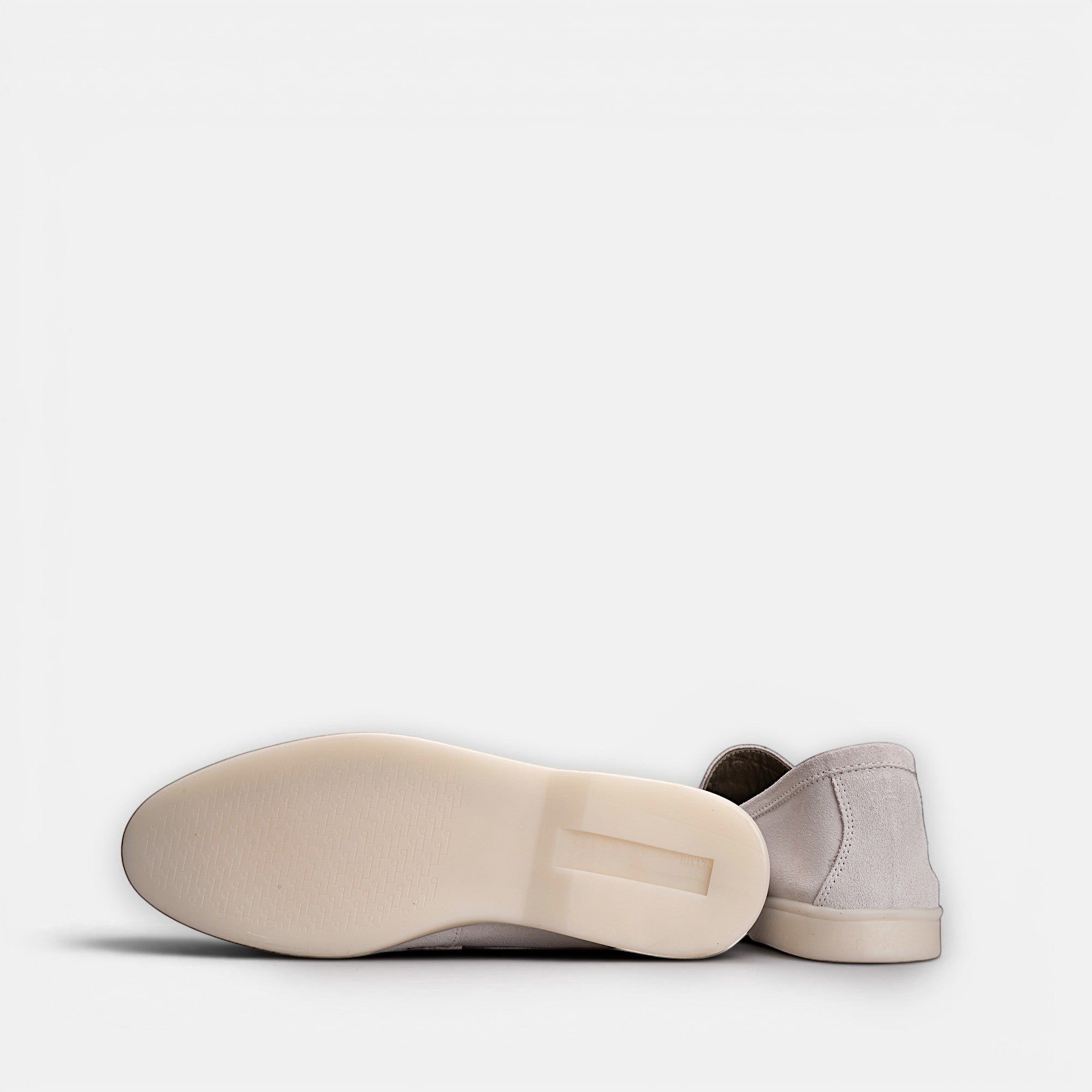 VOLZAK light beige suede moccasins with a durable rubber sole, shown from a side and bottom angle.