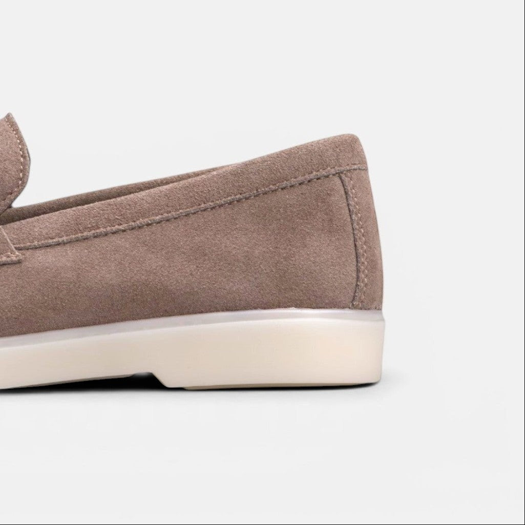 Close-up of the heel of a VOLZAK taupe suede moccasin with a durable rubber sole.