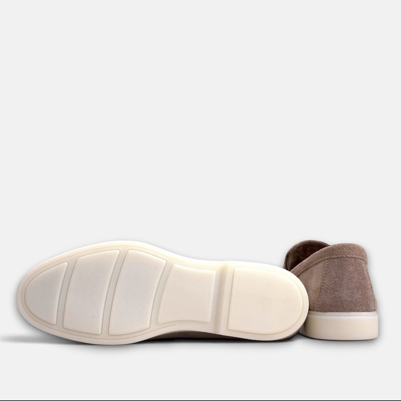 VOLZAK taupe suede moccasin showing the white rubber sole and heel detail against a plain background