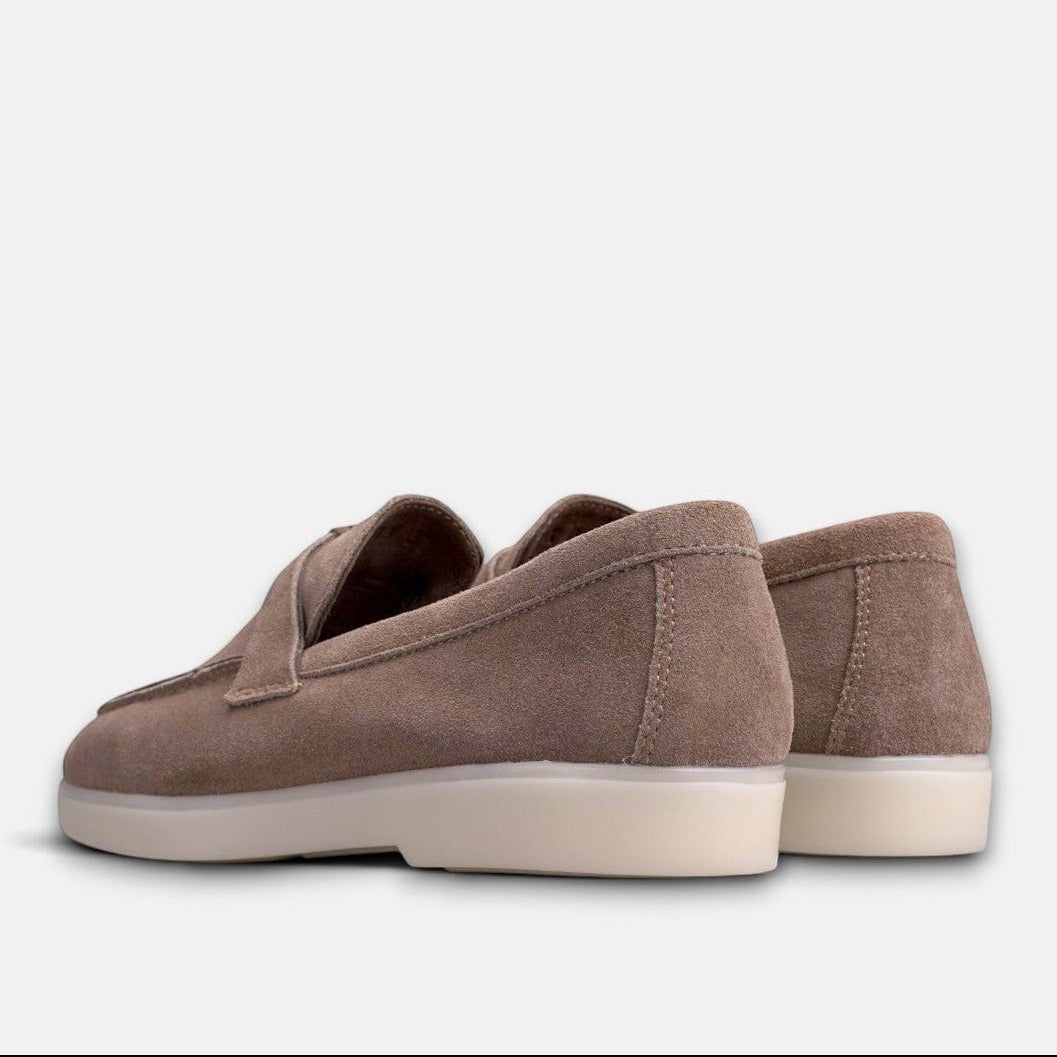 VOLZAK taupe suede moccasins with a white rubber sole, shown from a rear angle