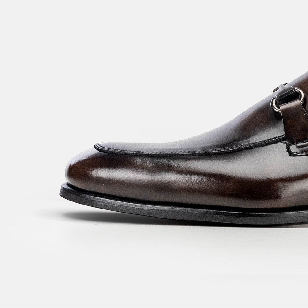 VOLZAK vintage brown leather loafer with a metallic buckle detail, showcasing premium craftsmanship and stitching.