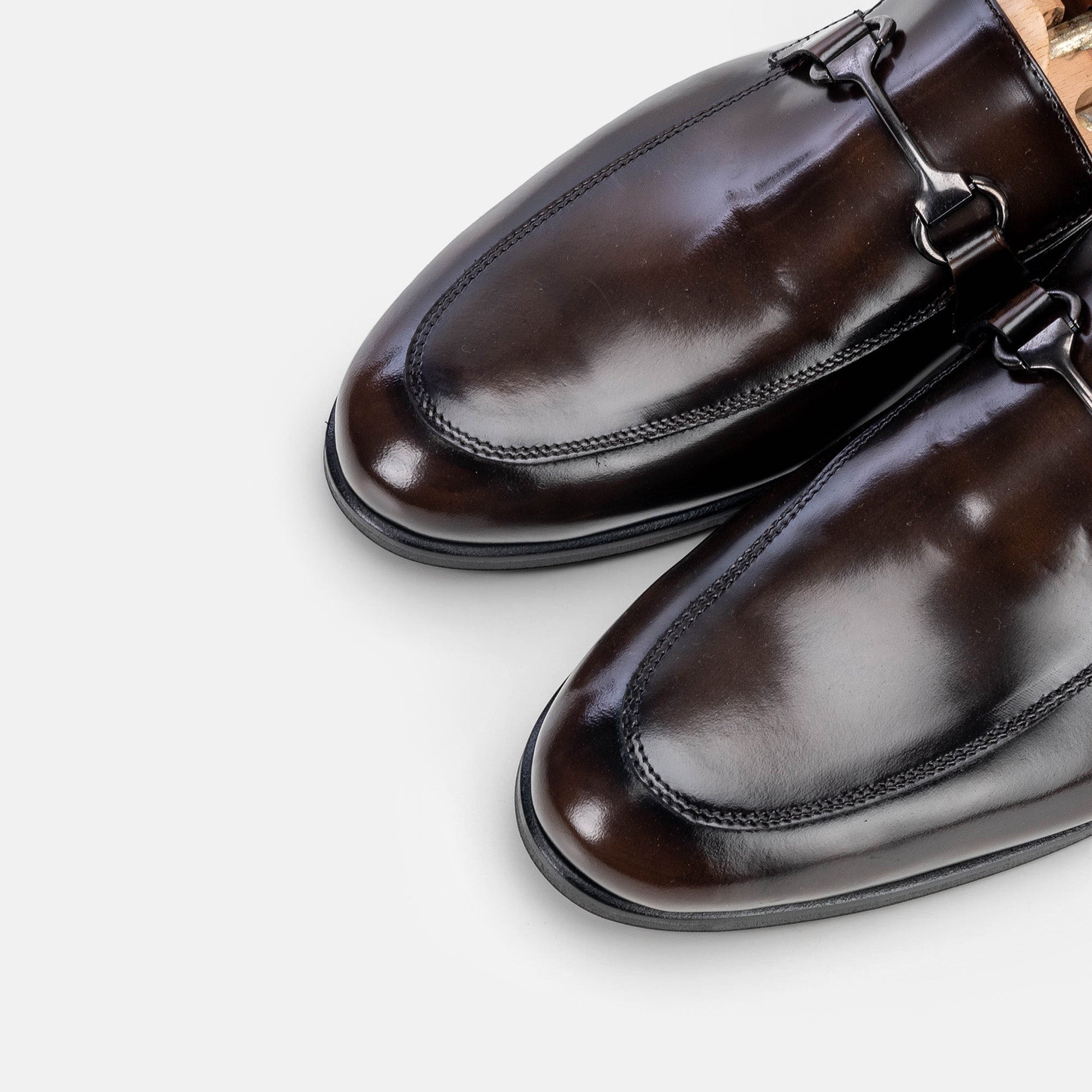 VOLZAK vintage brown leather loafers with a polished finish and metal bit detail on a white background